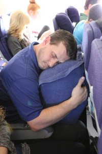 Brian using the travel pillow he got for Christmas.