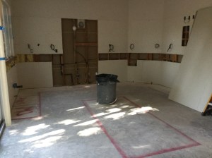 Electric & plumbing done; appliances and island locations painted on floor.