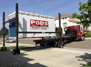 The driver then pulls the flatbed out from under the suspended POD.