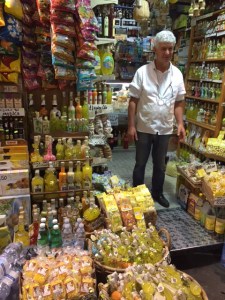 A shop keeper with lots of lemon products.