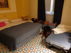 A double bed and two twins crammed into an already small room.