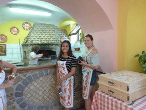 Hailey and Holly waiting their turn to throw pizza dough in the air.